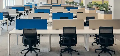 Modern open-plan office space featuring clean workstations, ergonomic chairs, and sanitized carpets provided by professional office cleaning services in Tucson, AZ.
