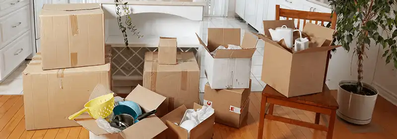 Packed moving boxes and household items in a kitchen before move-out or move-in cleaning, Tucson, AZ.